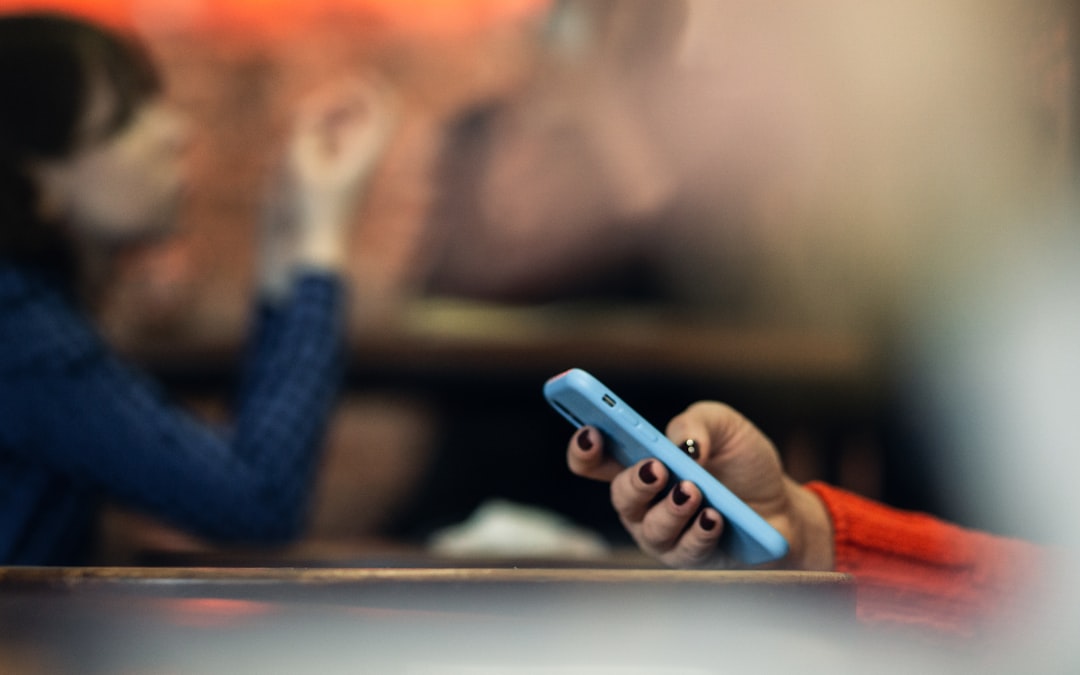 a person holding a cell phone in their hand