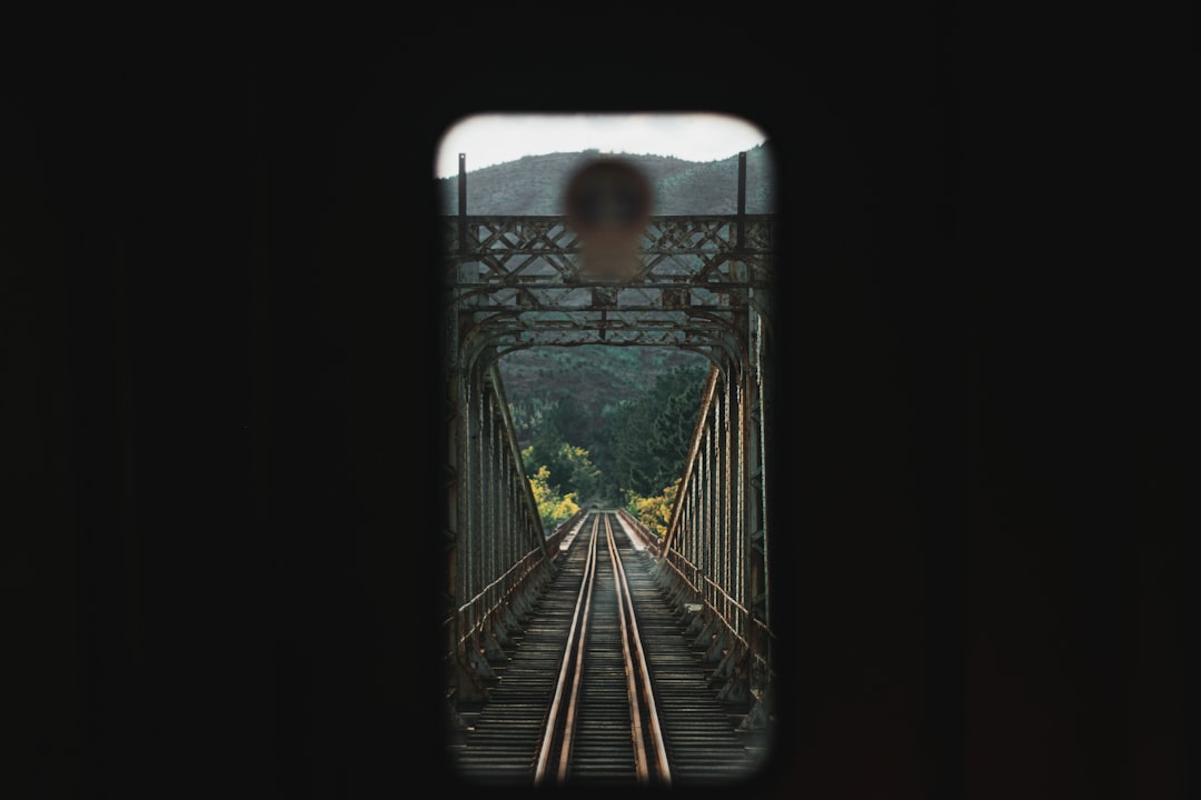a view of a train track through a window