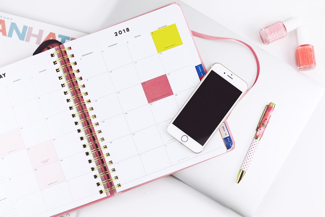 silver-colored iPhone 6 on a white spiral notebook