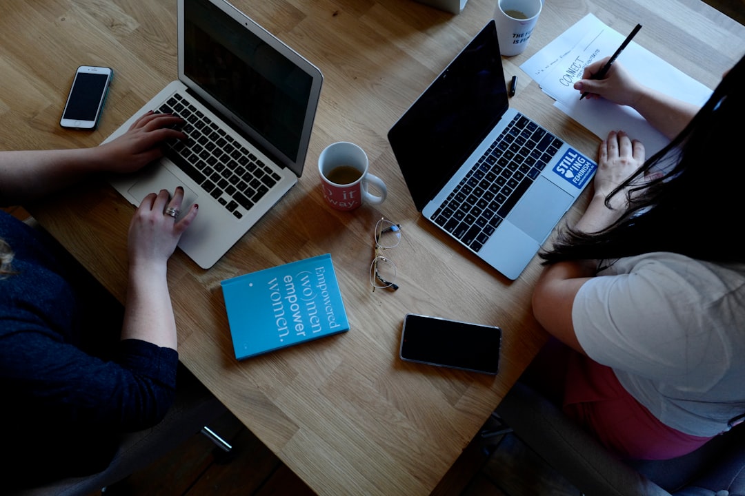 two people using laptops