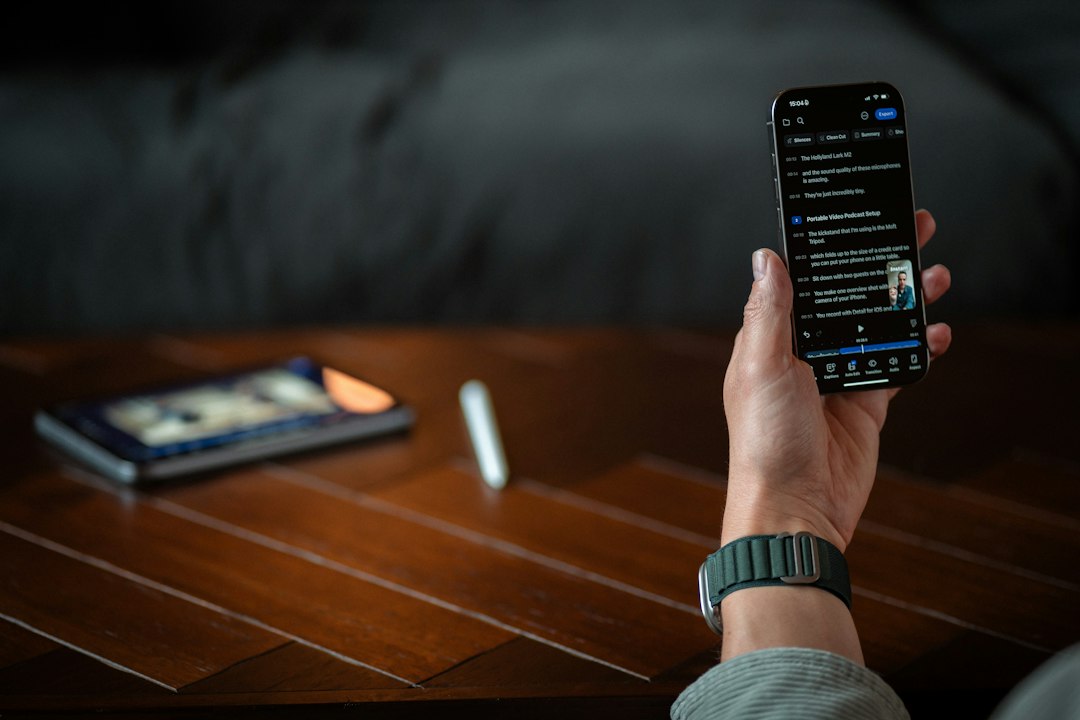 Person holding a smartphone with a dark screen